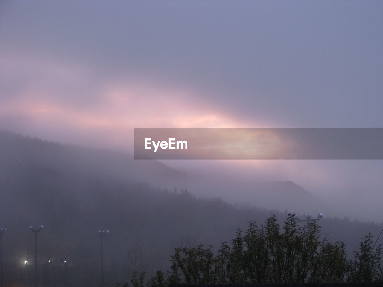 SCENIC VIEW OF TREE MOUNTAINS AGAINST SKY AT NIGHT