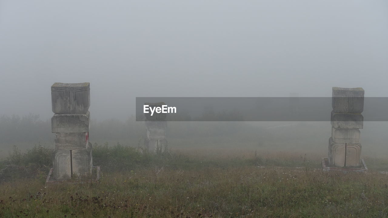 FENCE ON FIELD AGAINST SKY