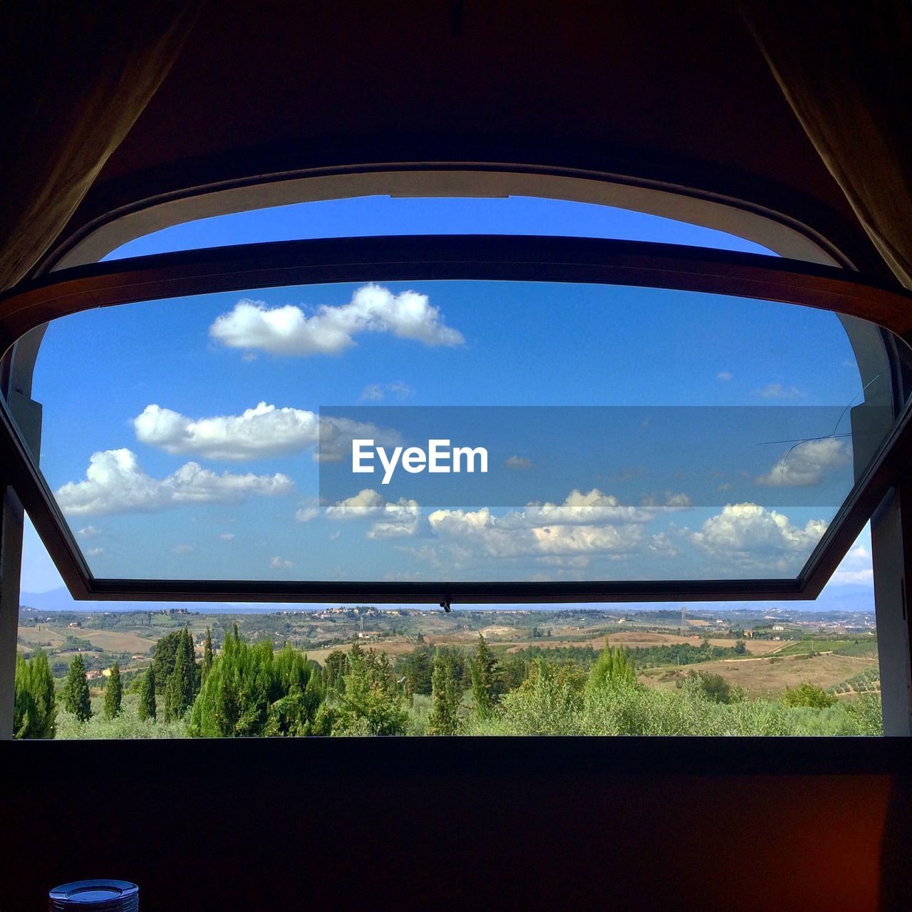Scenic view of landscape against sky seen from window