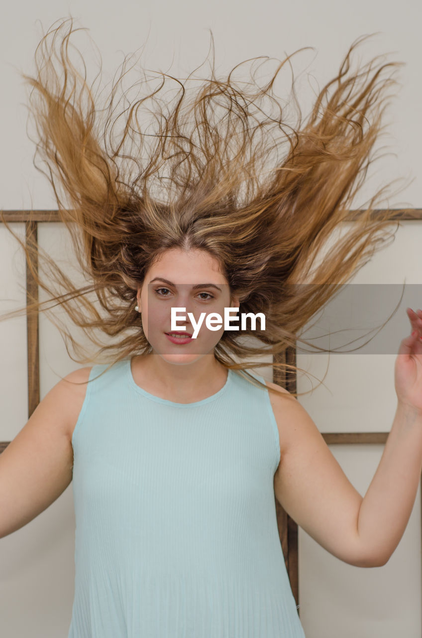 Portrait Of Young Woman With Tousled Hair Standing On Eyeem