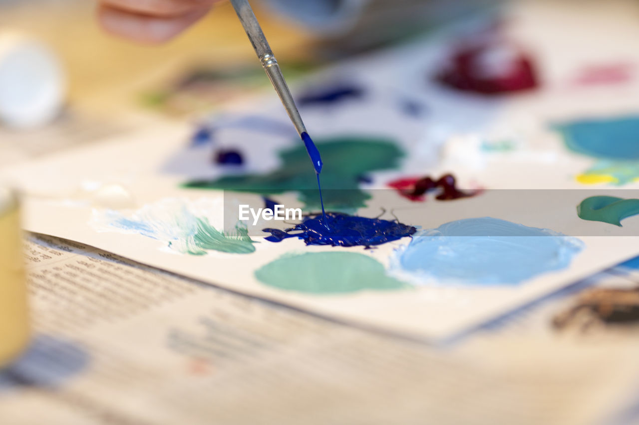 Close-up of multi colored paint on table
