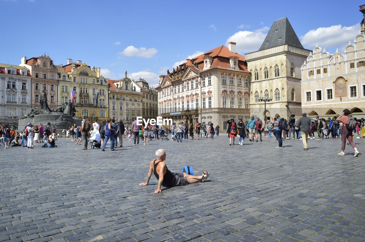 GROUP OF PEOPLE IN TOWN SQUARE