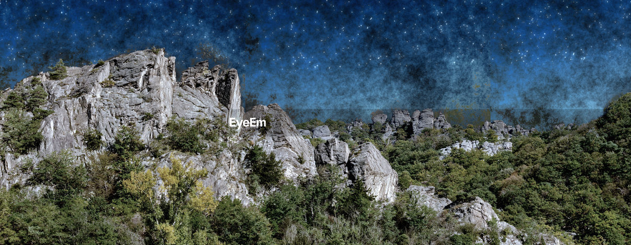 PANORAMIC VIEW OF ROCK FORMATION ON MOUNTAIN AGAINST SKY