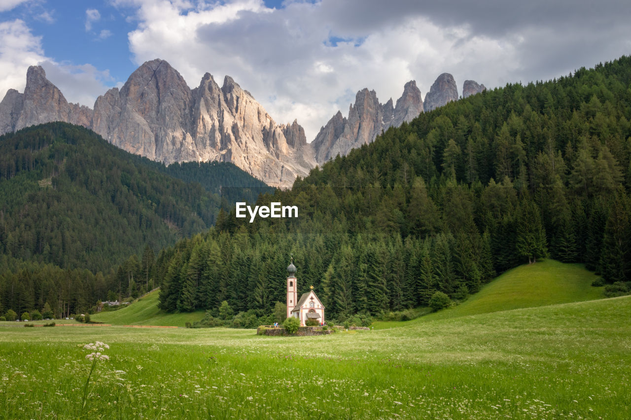 Scenic view of chapel in ranui, santa maddalena, in front of odles group mountains against sky 