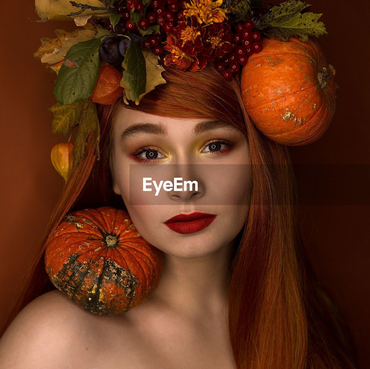 Portrait of young woman with decorative vegetables 