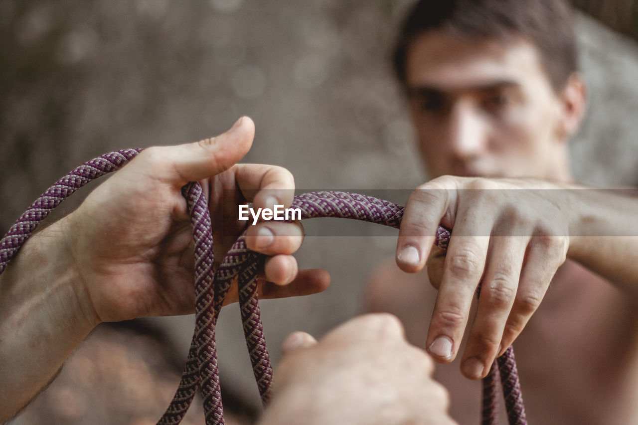 Close-up of hands holding rope