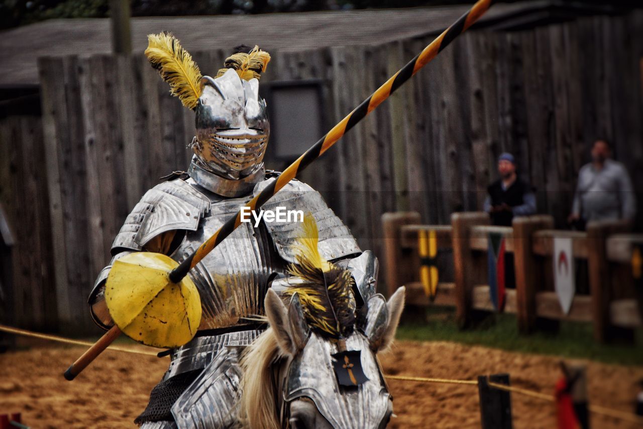 Knight in armor riding horse