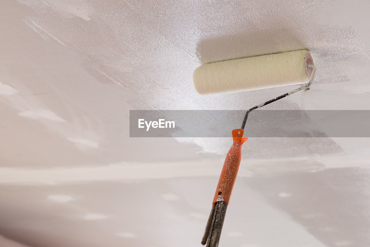 Workers Are Using Paint Roller On The Ceiling On Eyeem