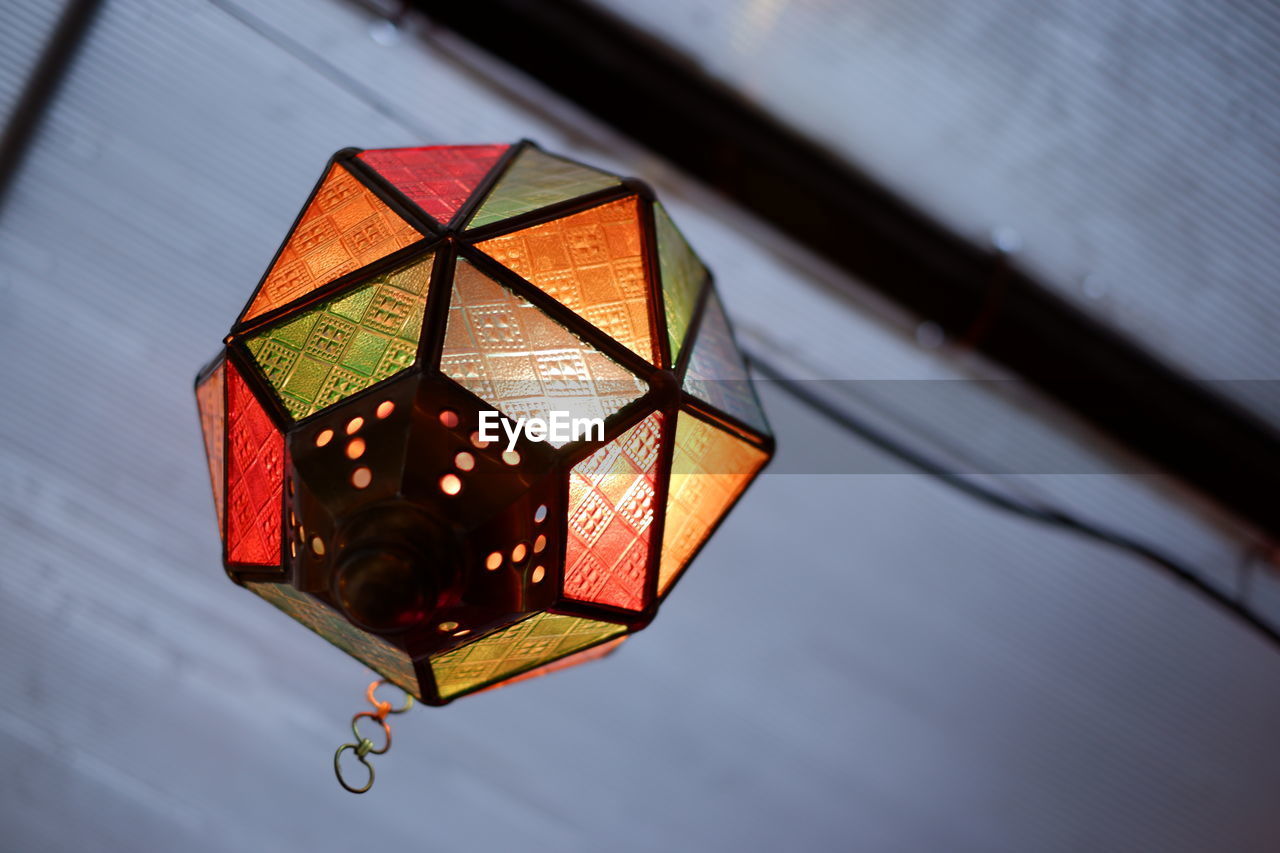 Low angle view of illuminated lantern hanging on ceiling