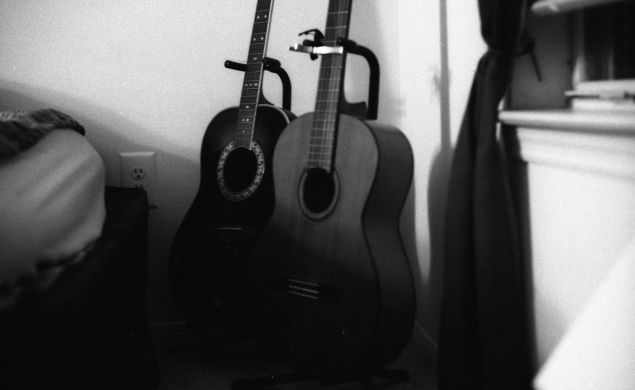 CLOSE-UP OF GUITAR IN THE MIRROR