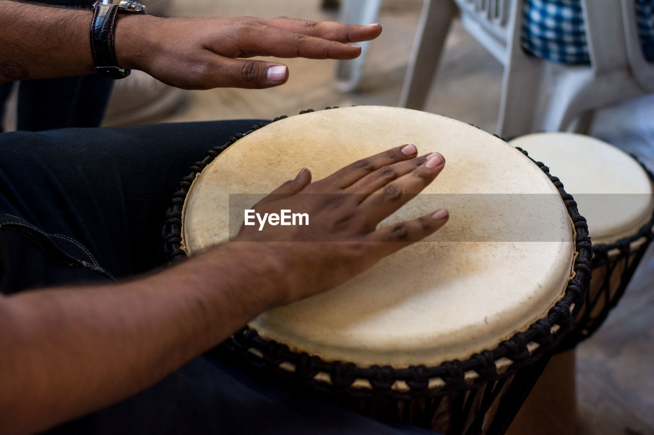 Close-up of hands playing drum
