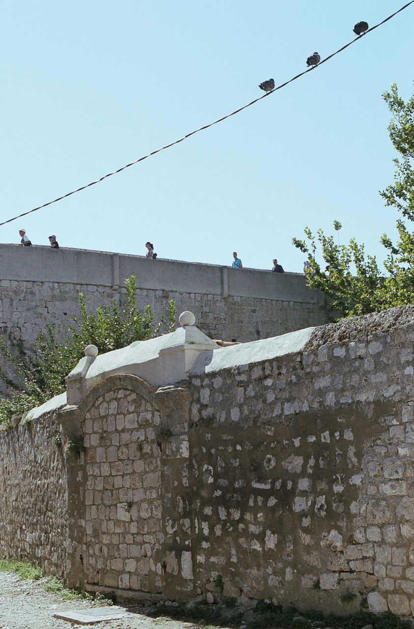Stone wall against clear sky