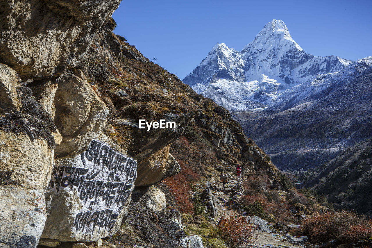 Buddhist script below the peak of ama dablam on the trail to everest.