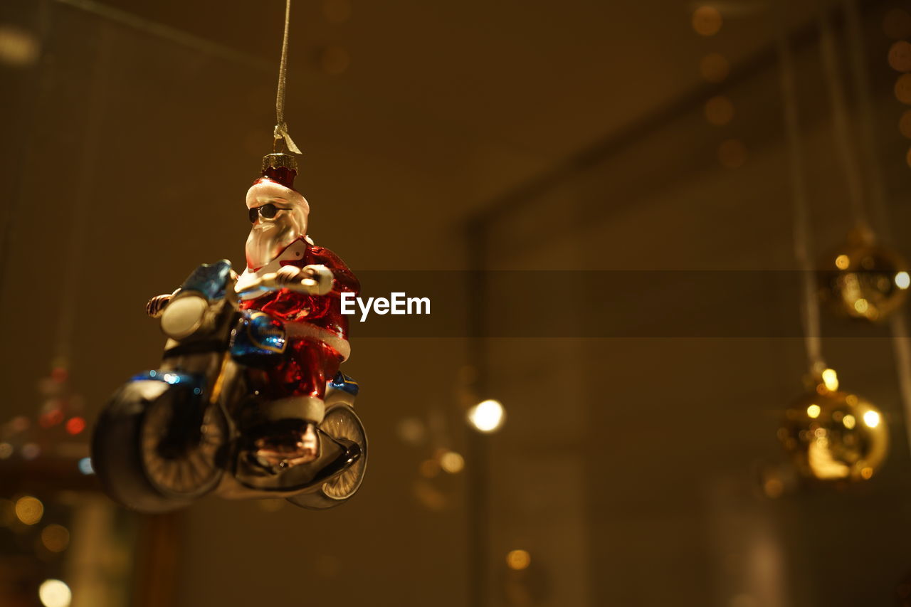 Low angle view of santa clause toy hanging indoors