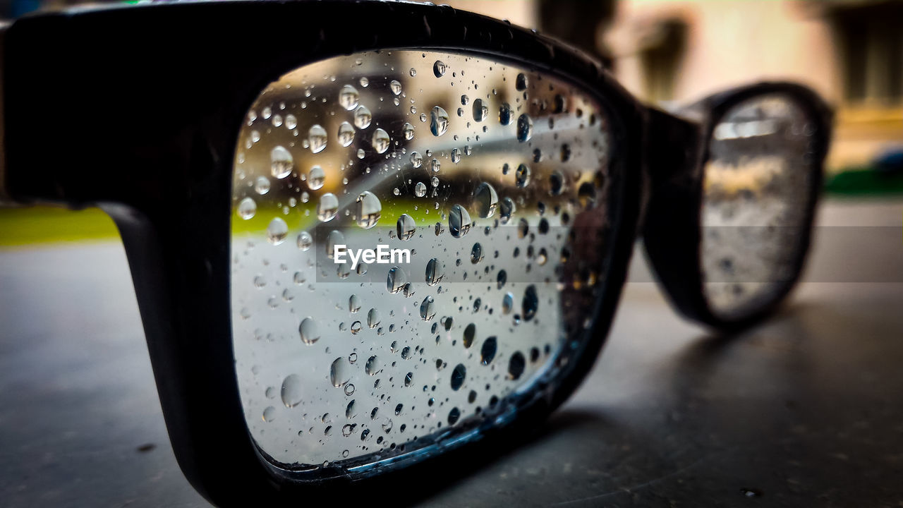 Close-up of wet eyeglasses on table
