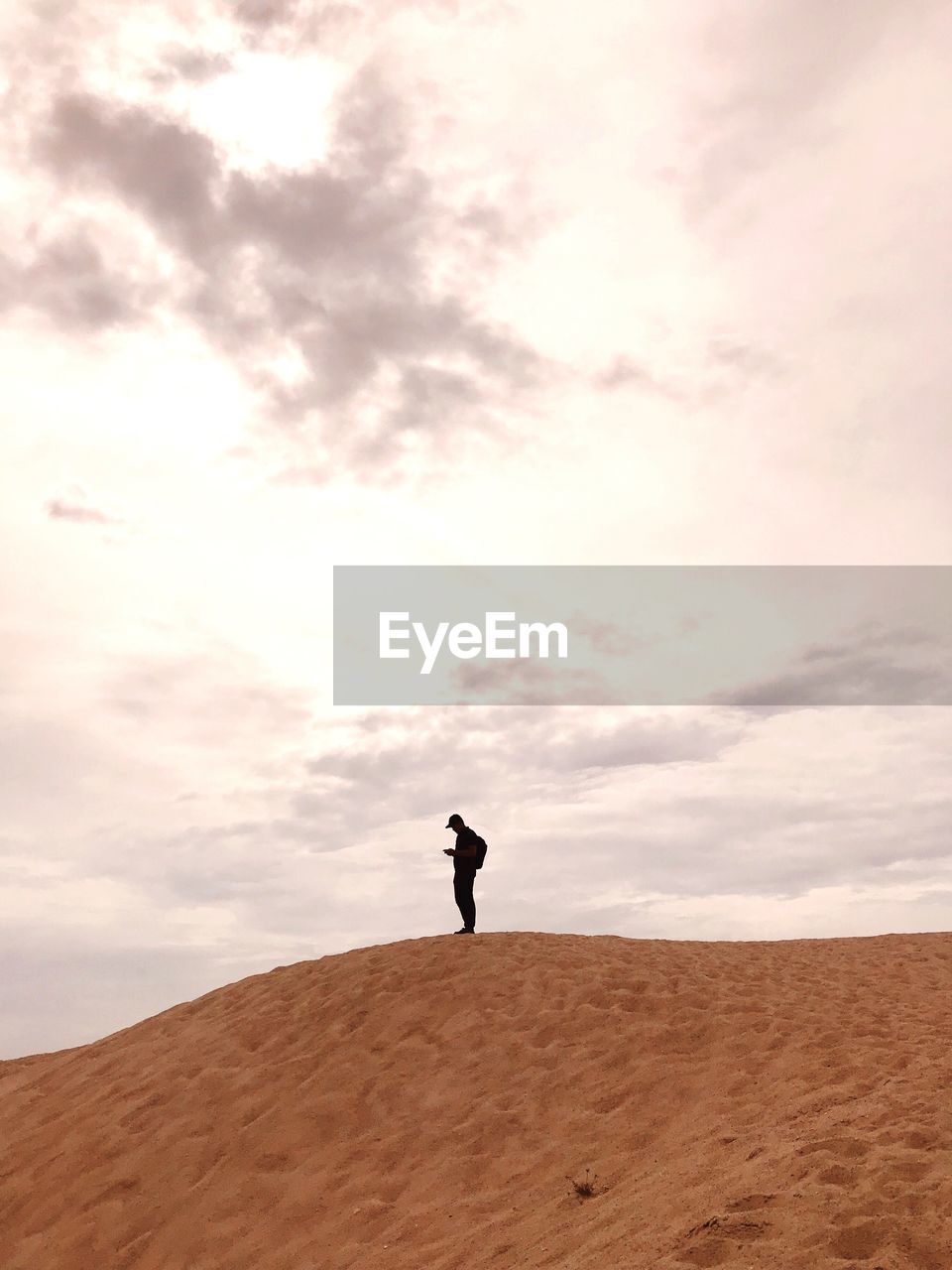 MAN STANDING IN DESERT