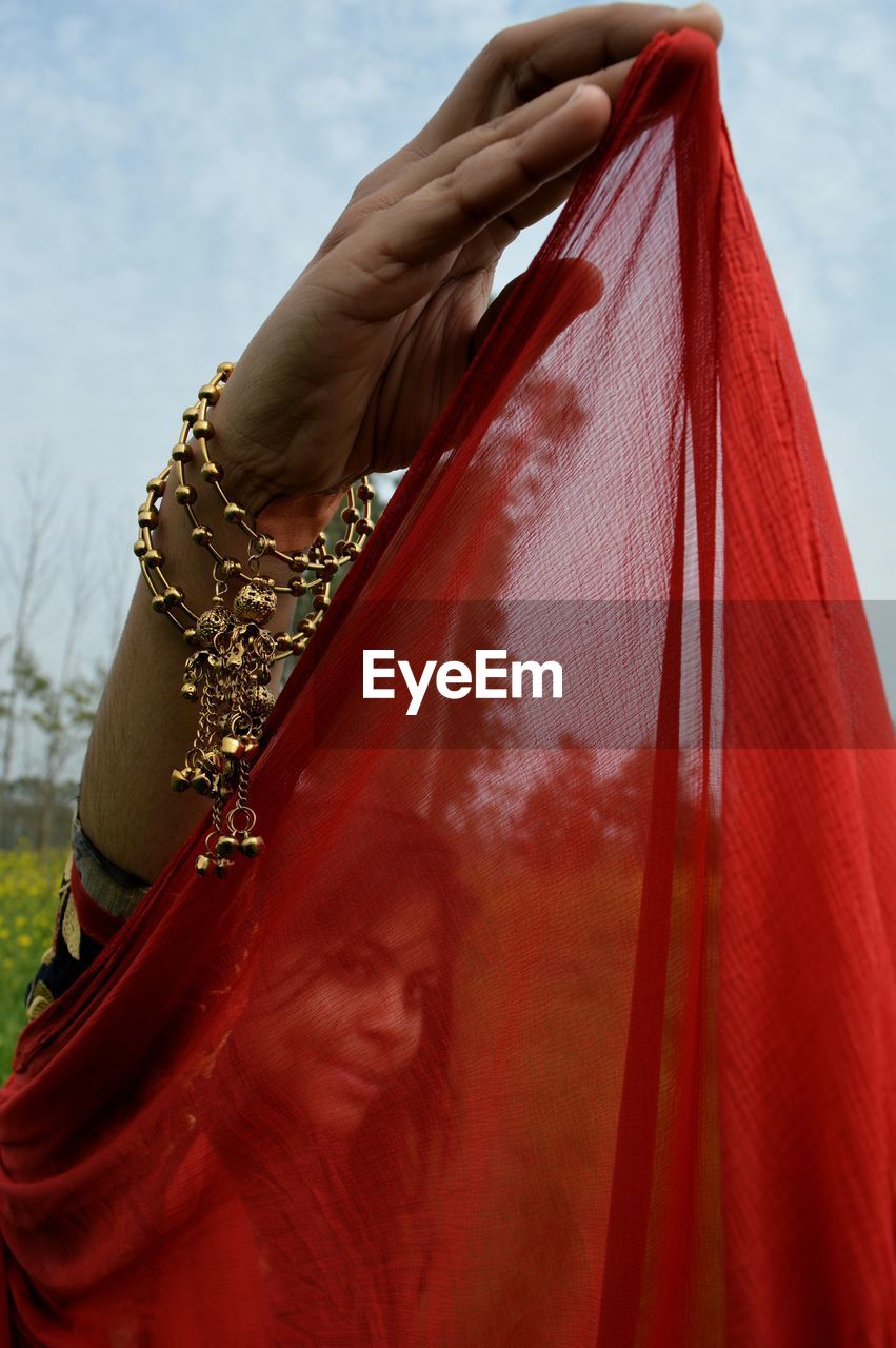 Portrait of teenage girl seen through scarf while standing outdoors