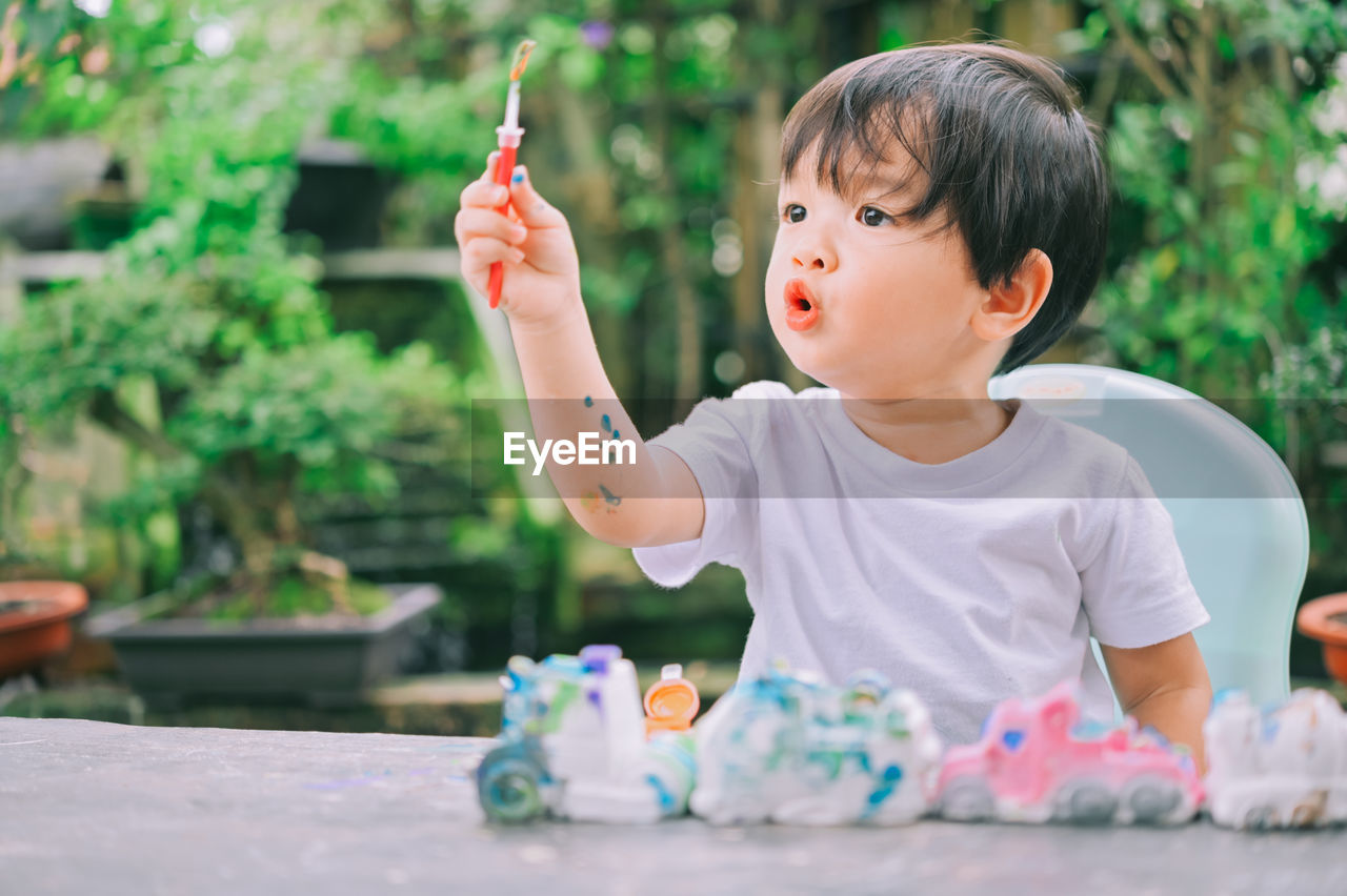 Cute boy playing with toy