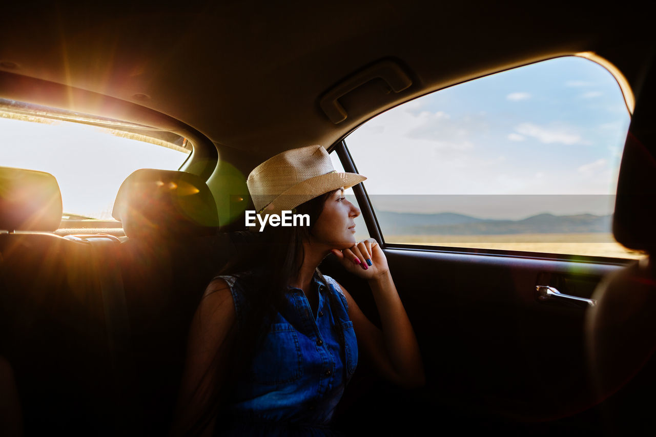 Woman looking at car window