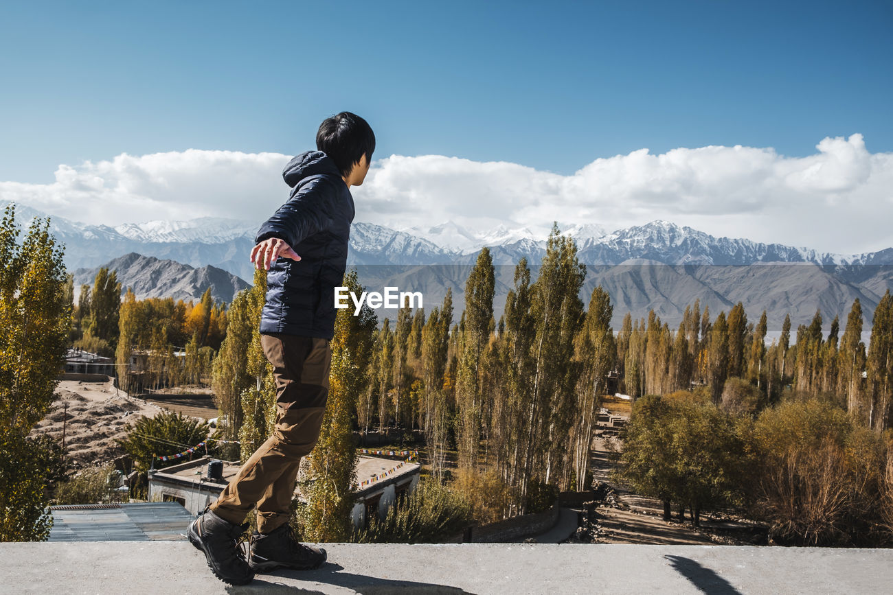 Side View Of Man Standing On Retaining Wall Id 142368749 A gravity retaining wall, for example, depends on its own weight and is usually shorter in height than. eyeem