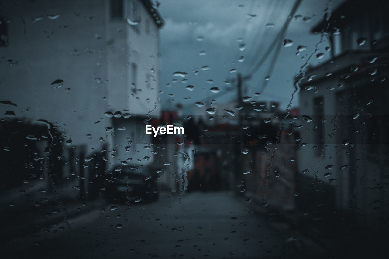 Full frame shot of wet glass window in rainy season
