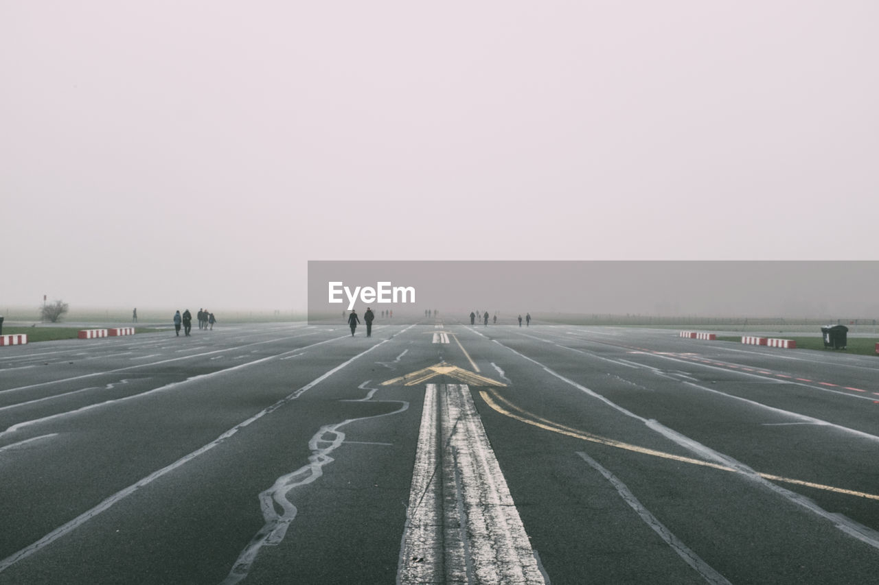 Distance shot of people walking on road