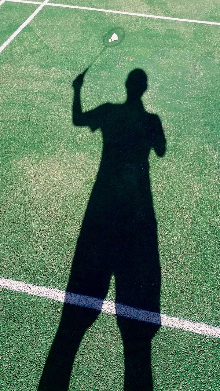 Shadow of man on badminton court
