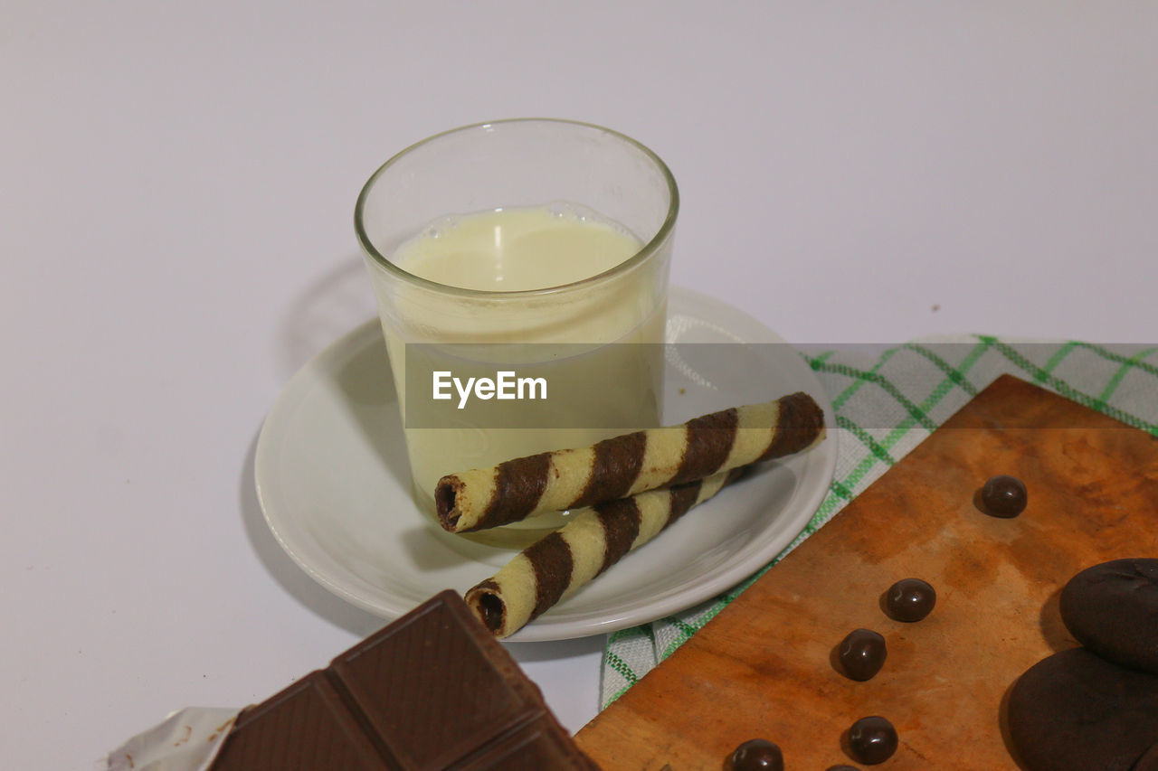 HIGH ANGLE VIEW OF DRINK IN PLATE ON TABLE