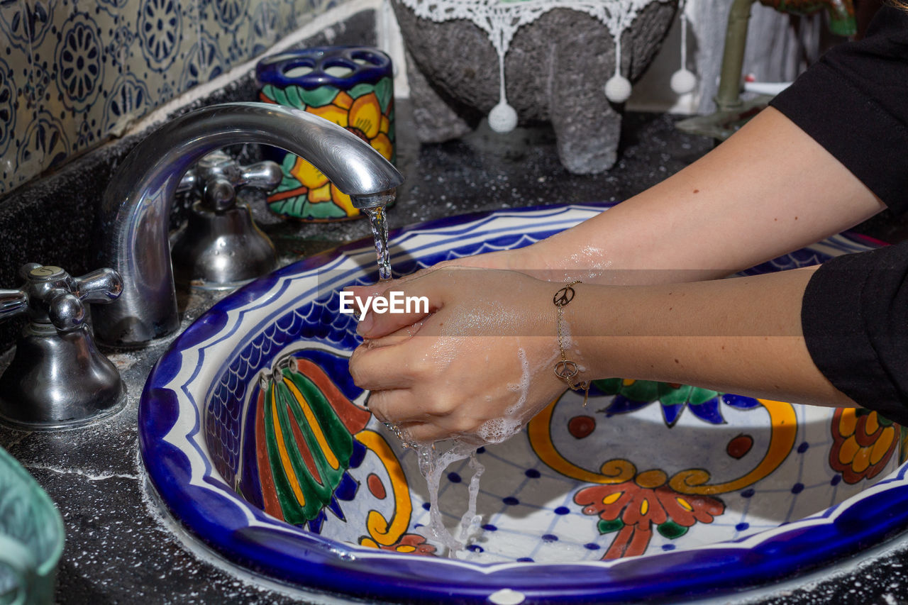 MIDSECTION OF WOMAN IN WATER AT HOME
