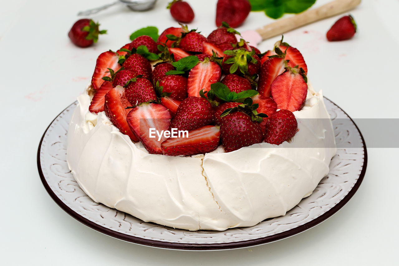 Homemade cake pavlova with strawberries on top - sweet food