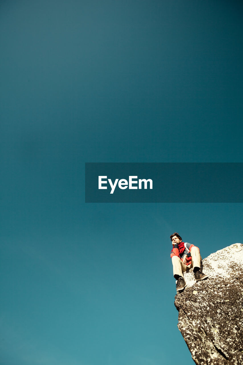 LOW ANGLE VIEW OF ROCK AGAINST BLUE SKY