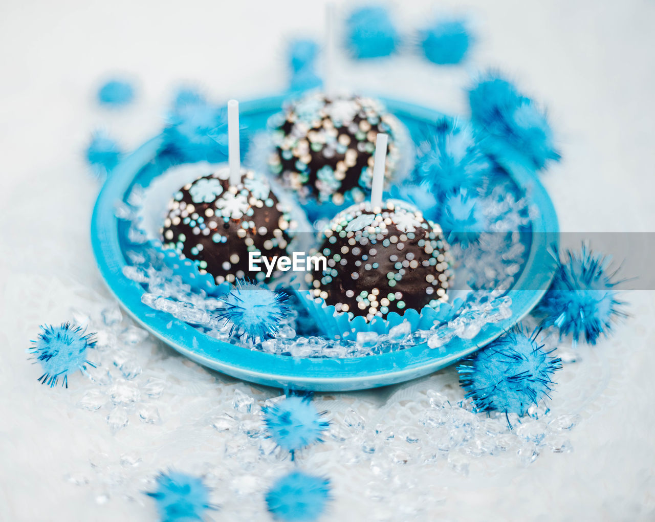 Assorted chocolates confectionery in a blue bowl. dark chocolate sweetness for dessert. party treats