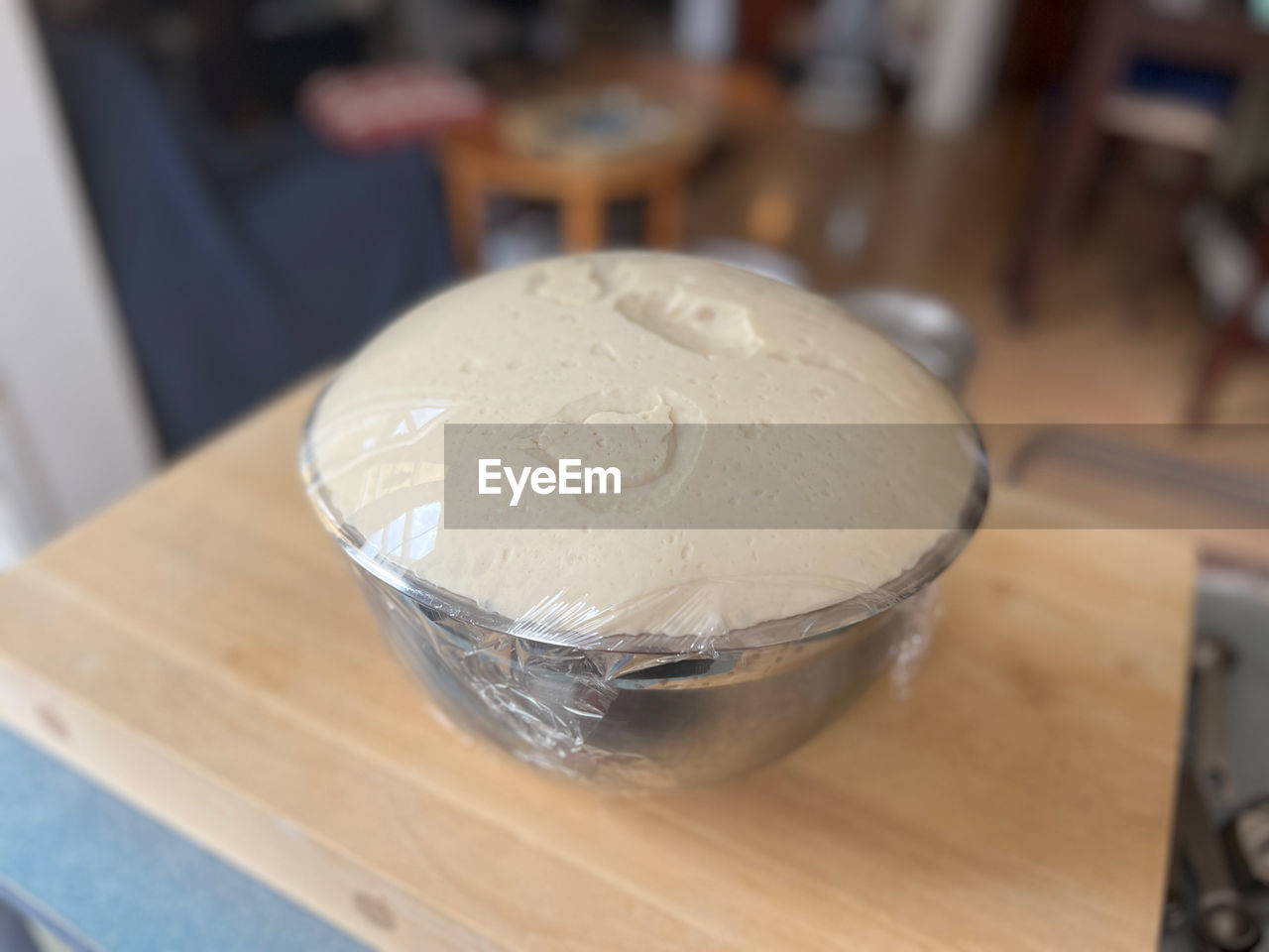 food and drink, indoors, food, baked, table, focus on foreground, wood, icing, dairy, close-up, ice cream, dessert, no people, freshness, still life, household equipment, bowl, business, sweet food