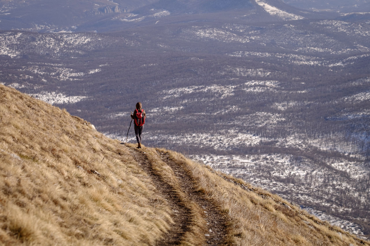 Full length of man walking on mountain track