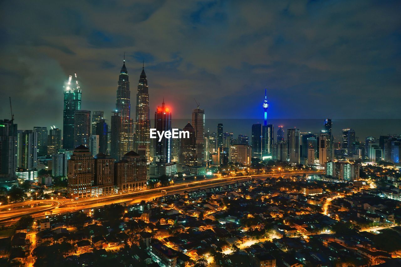 High angle view of city lit up at night