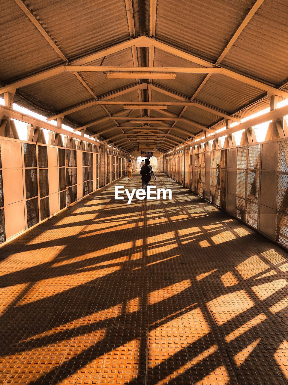 Rear view of man walking in corridor