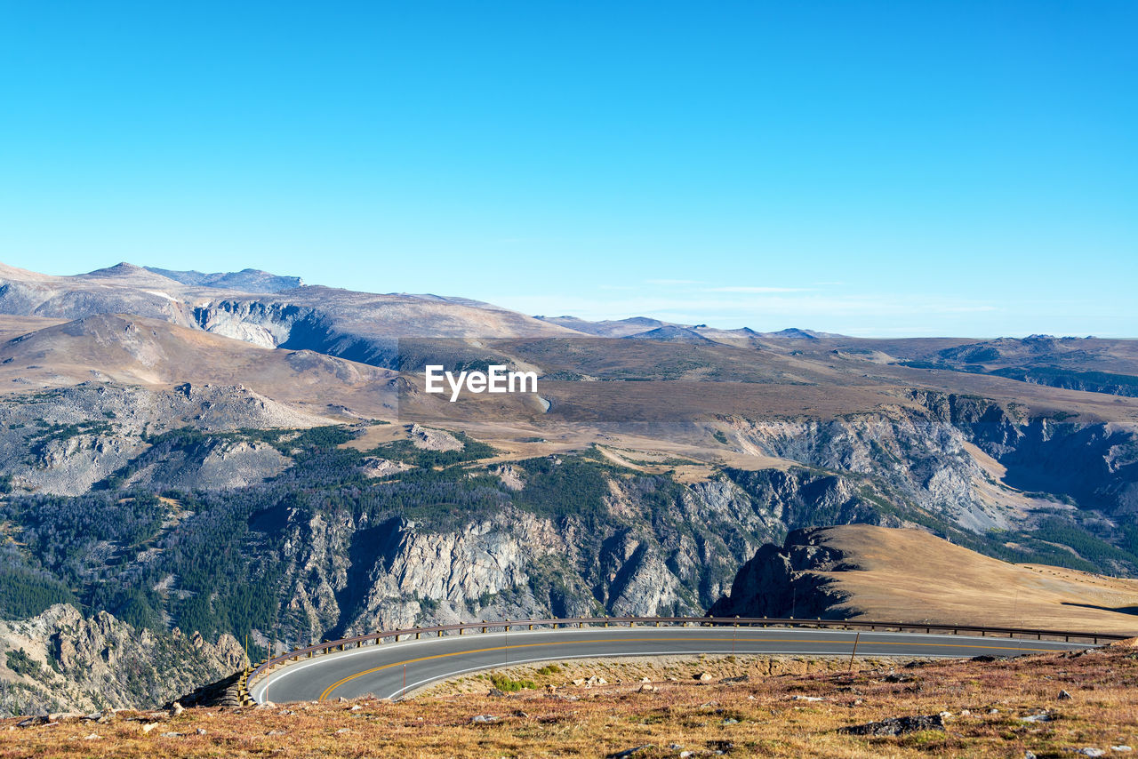 High angle view of highway by beartooth mountains against sky at yellowstone national park