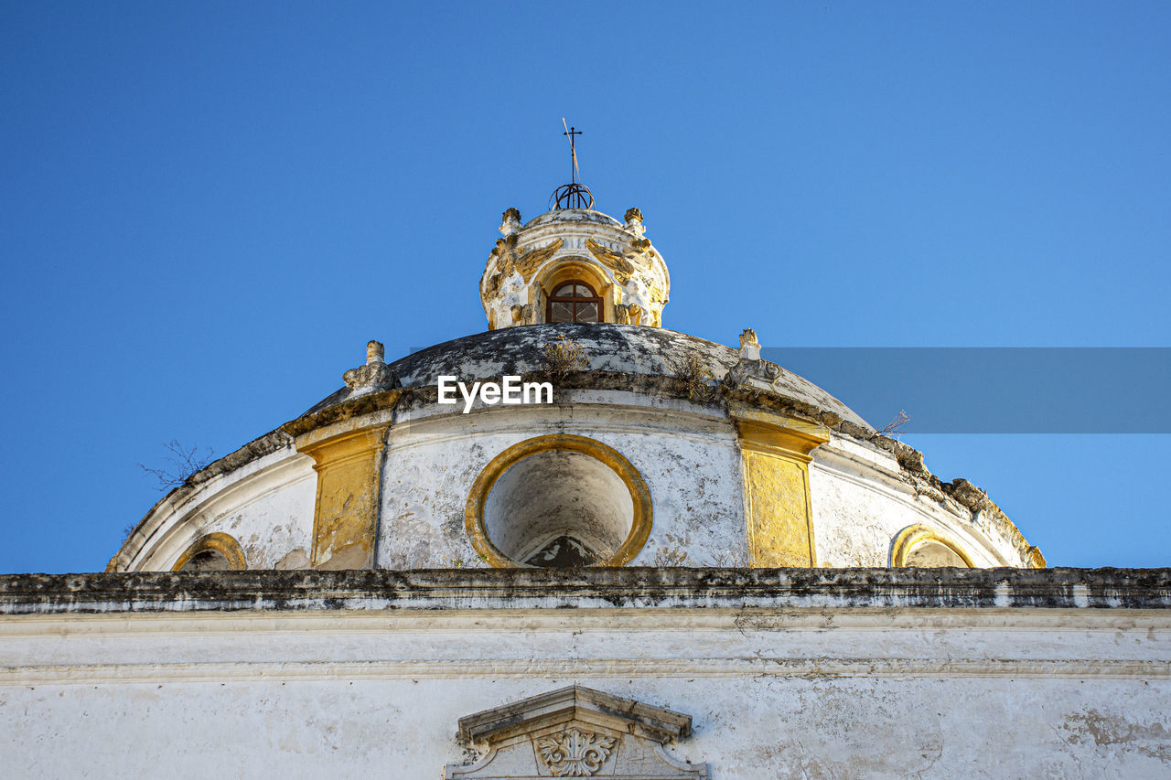 Low angle view of historic building against clear blue sky