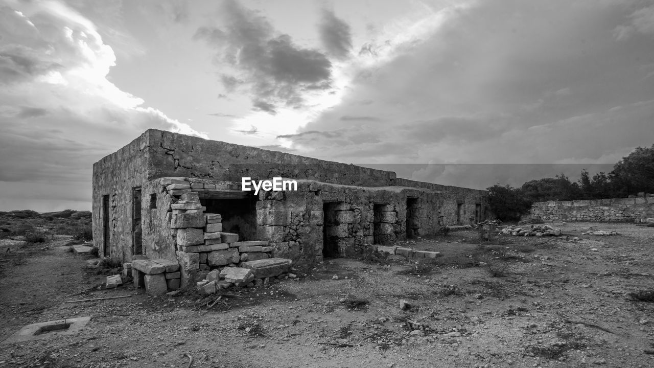 architecture, sky, cloud, ruins, built structure, history, abandoned, the past, landscape, nature, rural area, land, building, old ruin, old, environment, building exterior, no people, house, ruined, monochrome, black and white, damaged, ancient history, rural scene, rundown, ancient, scenics - nature, outdoors, hut, monochrome photography, stone material, rock, white, weathered, dramatic sky, spooky, travel destinations, travel, day, bad condition