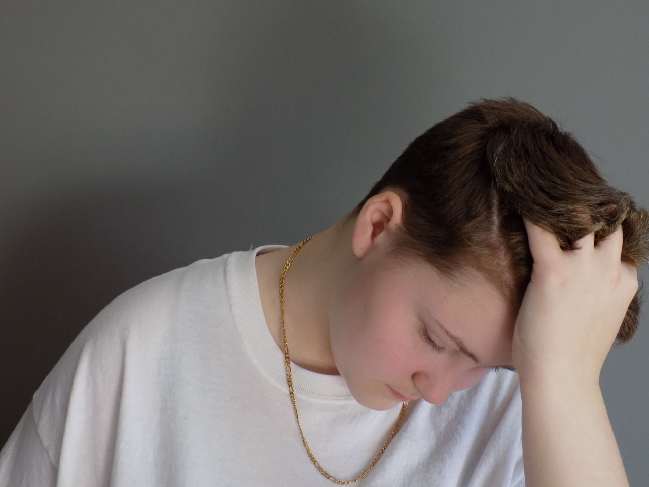 Close Up Of Sad Teenage Boy Against Gray Background On Eyeem