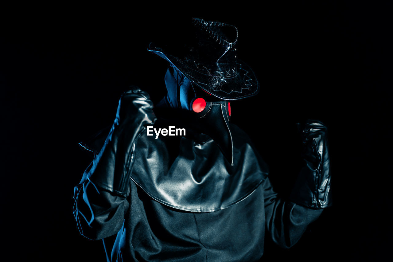 Person wearing costume against black background