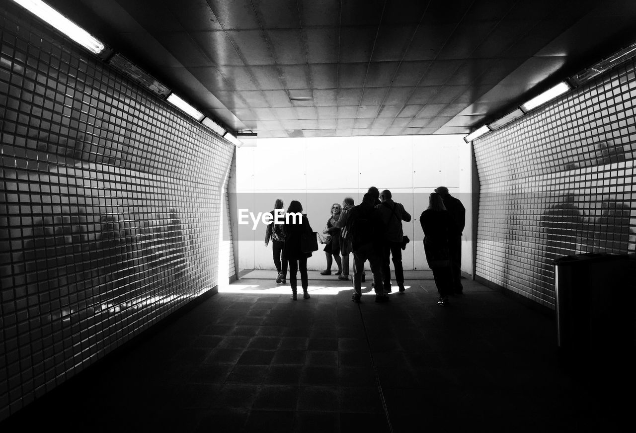 Group of people walking in tunnel