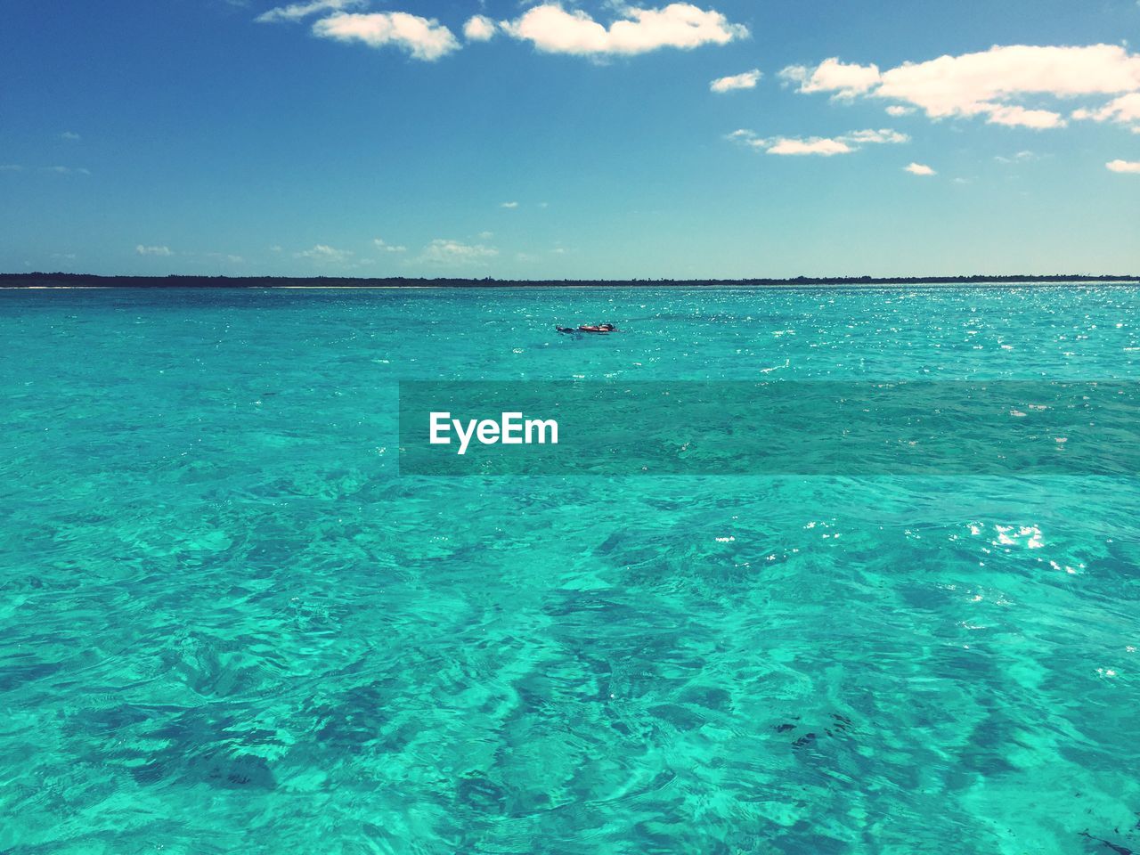 Scenic view of sea against blue sky