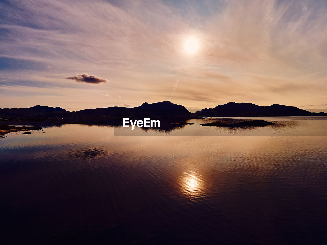 water, sky, reflection, scenics - nature, beauty in nature, tranquility, mountain, nature, cloud, dawn, sunrise, morning, sea, tranquil scene, horizon, sunlight, environment, landscape, no people, sun, land, mountain range, travel destinations, outdoors, idyllic, travel, dramatic sky, silhouette, beach