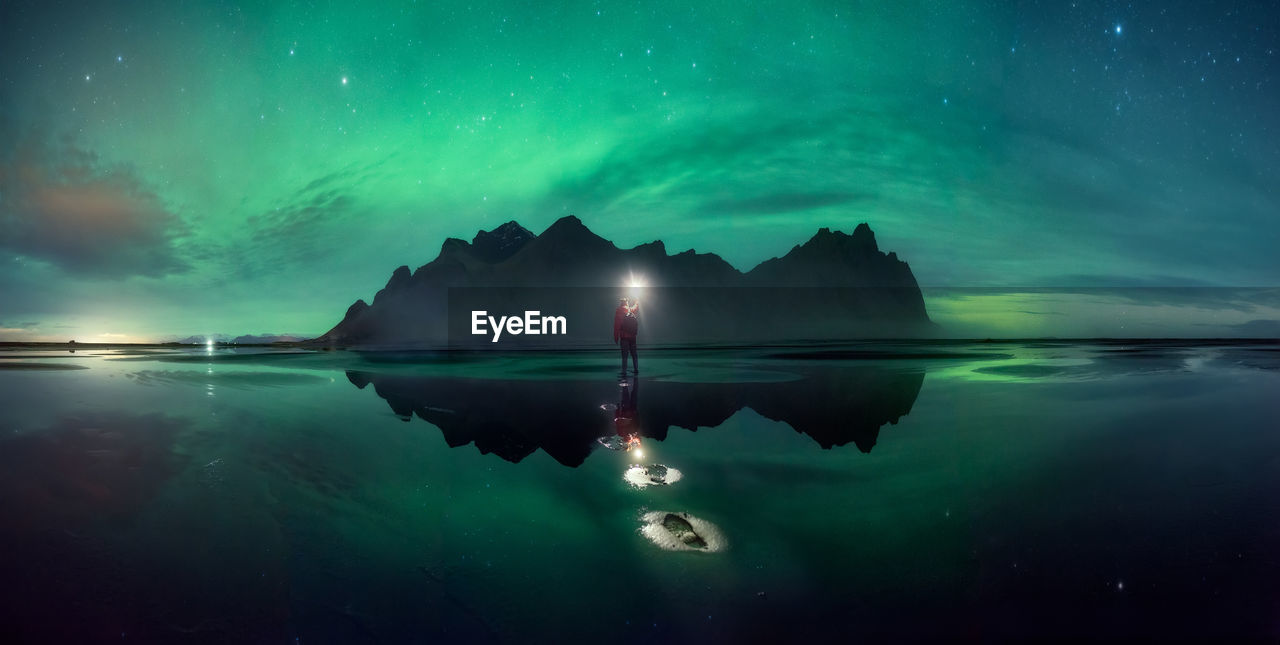Scenic view of lake against sky at night
