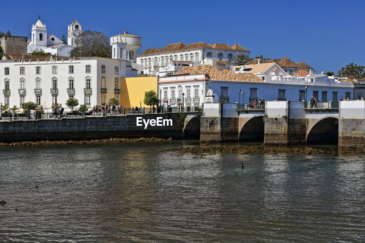 arch bridge over river in city