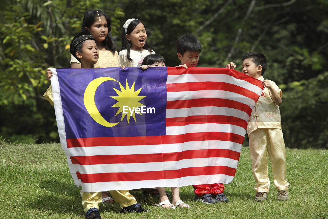 Friends Holding Malaysia Flag While Id 122479564