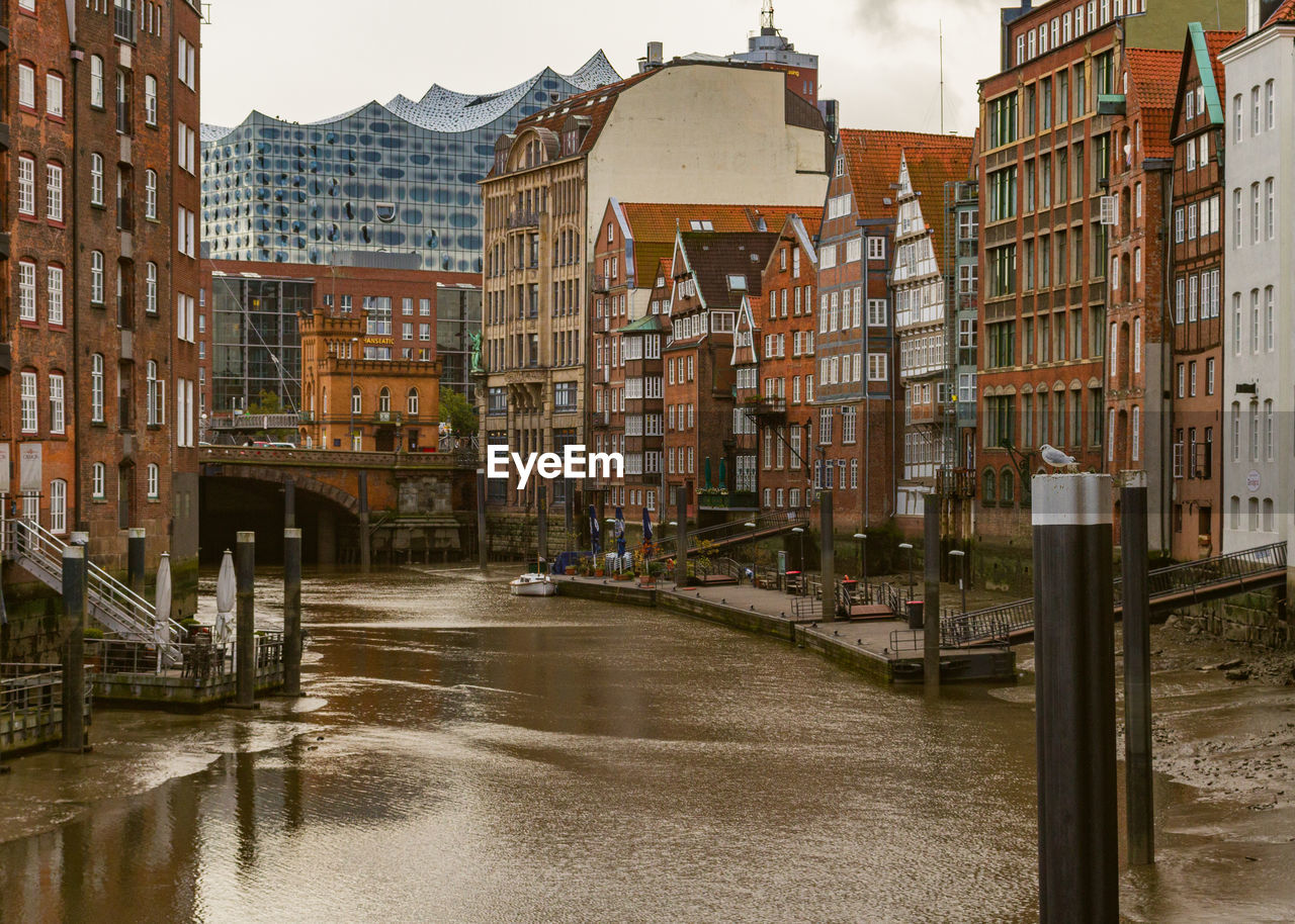 Bridge over canal amidst buildings in city
