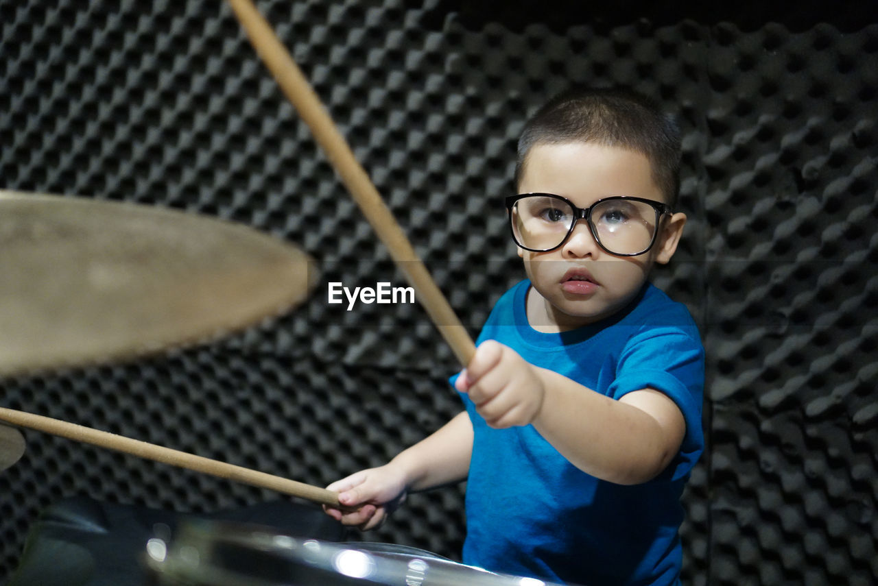 Portrait of boy playing drums