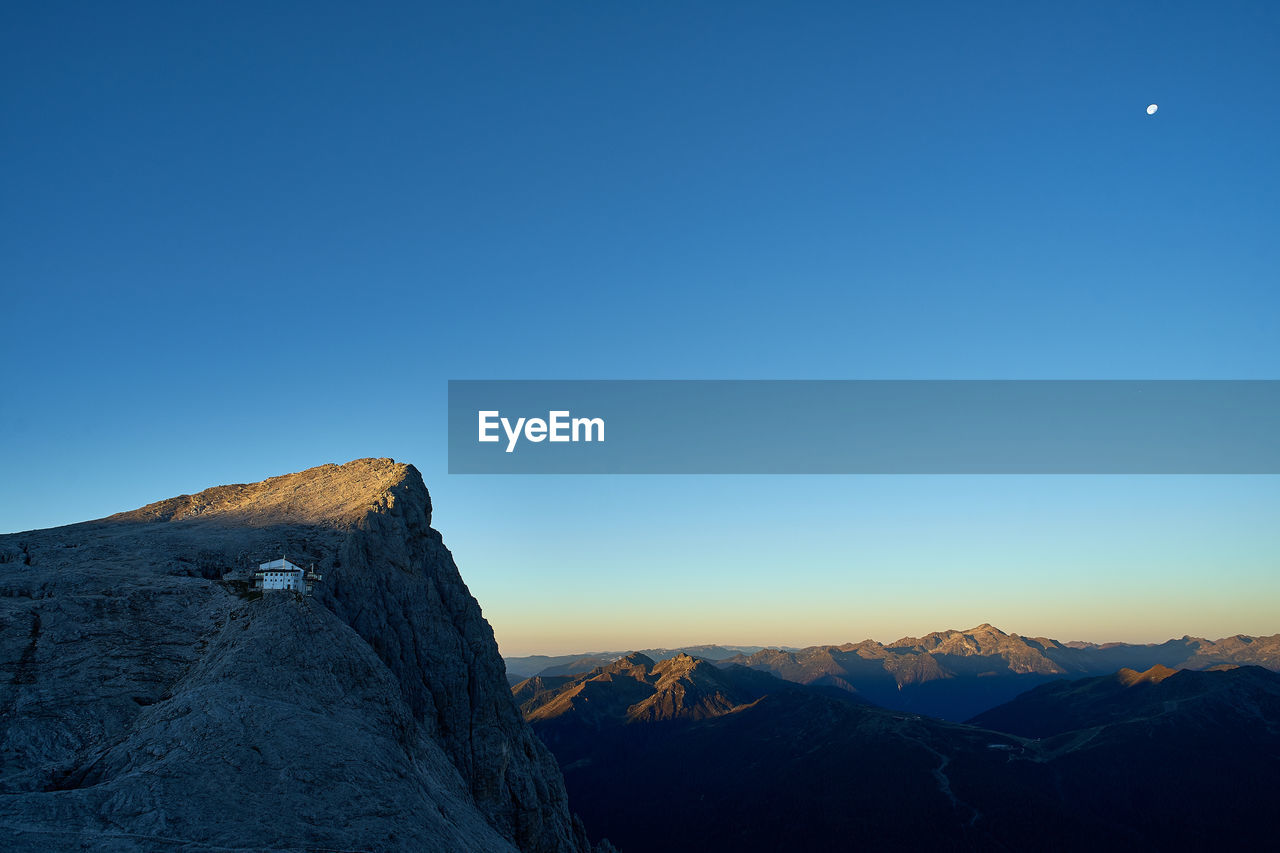 Scenic view of mountains against clear blue sky